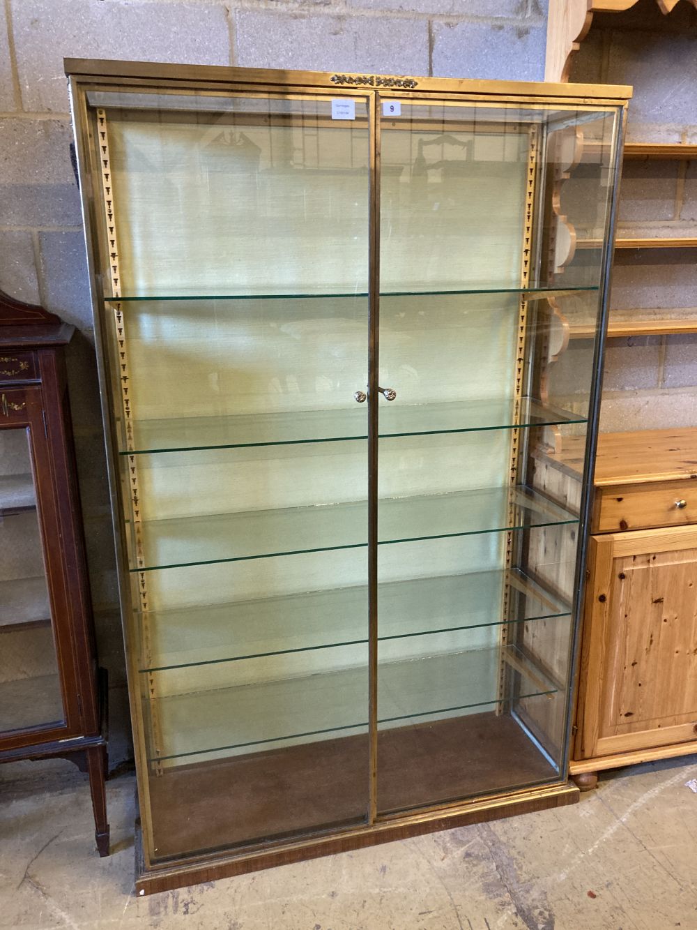 A gilt brass and plate glass collectors display cabinet, width 102cm, depth 33cm, height 162cm
